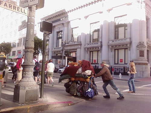Two Orange Cats Riding a Cart pushed by a homeless person in San Francisco